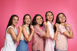 © New Africa - Happy women posing on pink background. Girl power concept