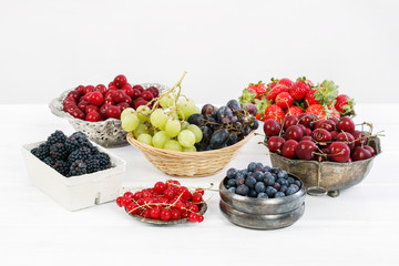 Sticker - Various summer fruits on a white wooden table.