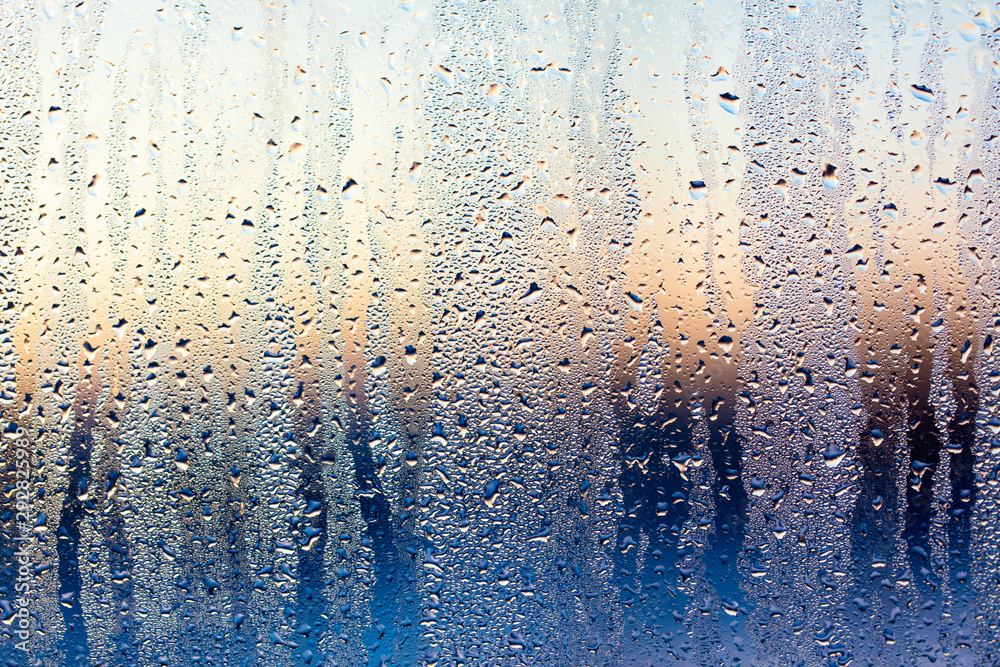 A foggy window at sunset as an abstract background - obrazy, fototapety, plakaty 