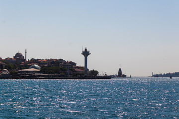 Wall Mural - distant view of the maiden's tower and a lighthouse in Istanbul, Turkey on a bright day