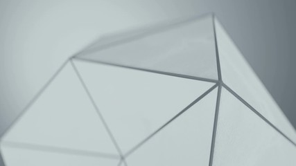 Poster - White polygonal shape with grunge surface. Abstract techno structure close-up. Seamless loop 3D render animation with shallow depth of field 4k UHD 3840x2160