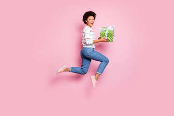 Poster - Full length body size photo of excited fast quick crazy funny girlfriend black skinned cute cheerful wearing jeans denim striped sweater holding giftbox with hands isolated pastel color background