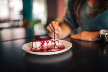 Woman having a dessert at restaurant closeup.