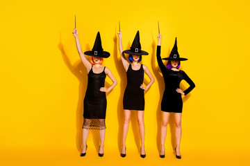 Wall Mural - Full length body photo of three dangerous terrifying horror disguise horrible angry ladies in high-heels using wands showing their magic powers isolated bright color background