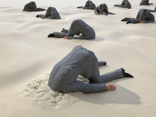 Group Of Businessmen Hides Their Heads In The Sand
