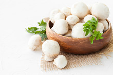 Fresh Mushrooms Champignon In Brown Bowl On White Background. 