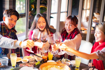 Wall Mural - Happy friends having fun in hot pot restaurant