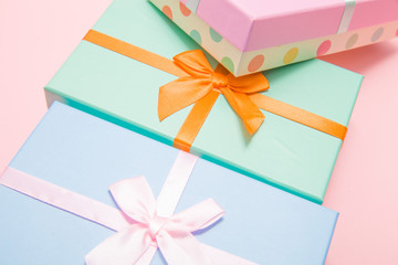 Poster - multi-colored boxes with bows on a pink background