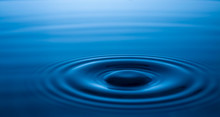 Water Surface With Waves Caused By The Impact Of Water Droplets. The Rings Of Water Background. Blurred,soft Focus,motionblur