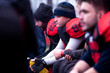 american football player resting with teammates