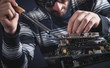 © andranik123 - Computer hardware engineering. Engineer soldering computer motherboard