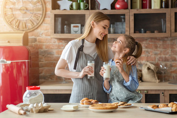 Wall Mural - Pretty mom and daughter spending time together at kitchen