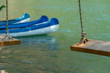 Wall Mural - Wooden Swing and Conoe in Background