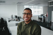 Leinwandbild Motiv Friendly and smiling young african american professional businessman looking at camera in modern office