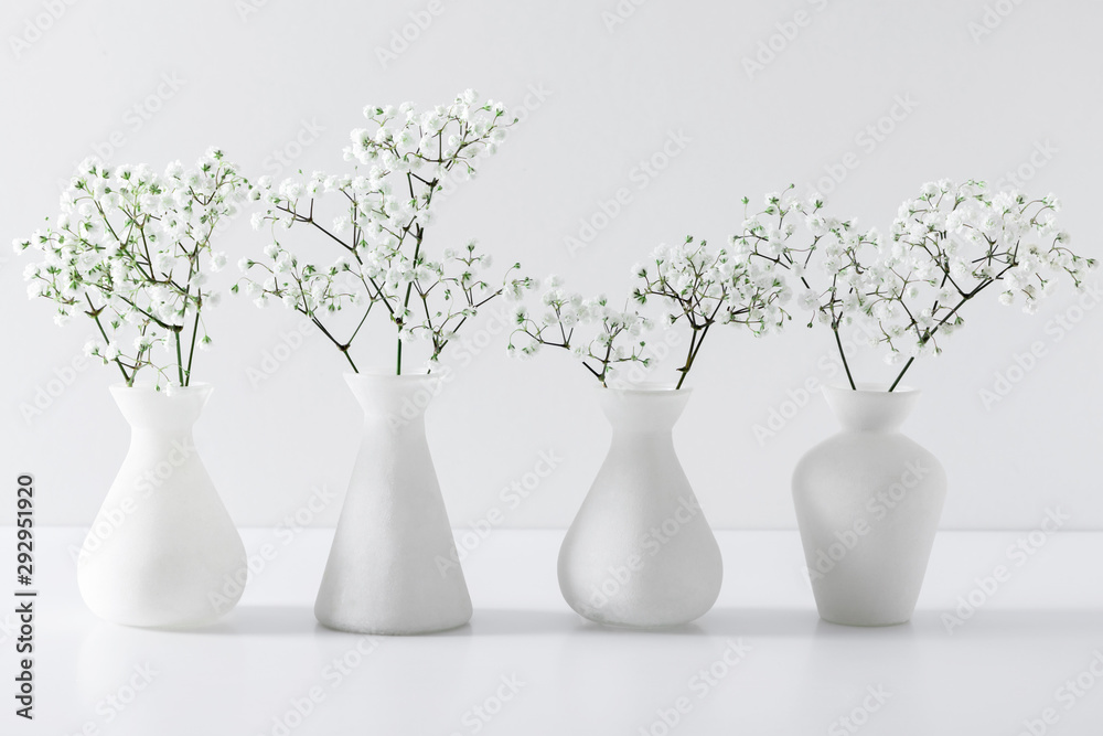 Home interior floral decor. Elegant floral soft white composition. Beautiful white gypsophila flower in vase on white wall background. - obrazy, fototapety, plakaty 
