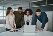 © StratfordProductions - Smiling multiethnic coworkers working together in office watching online project application on laptop over the office desk