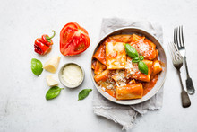 Pasta Paccheri With Tomato Sauce And Basil In A Plate, Top View