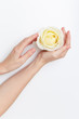 © Halyna - Female hands holding ivory rose. On the white background