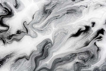 marble texture formed by mixing the black and white acrylic paint, abstract background