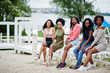 © AS Photo Family - Group of five african american girls relaxing at beautiful poolside cabana beside luxury resort.