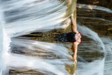 Woman Inside Waterfall Flow