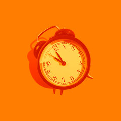 Wall Mural - Monochrome orange classic style alarm clock isolated on background. New Year and start up concept