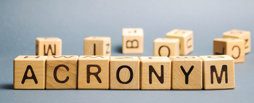 Wooden blocks with the word Acronym. Abbreviation from the initial components of a phrase or a word.