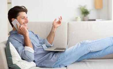 Poster - Careless Guy Talking On Cellphone Working On Laptop At Home