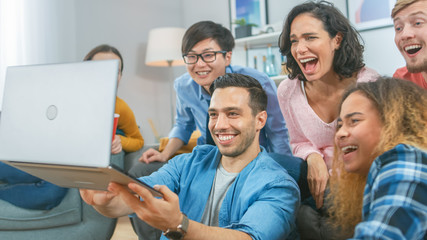 Wall Mural - Diverse Group of Friends Use Laptop in the Living Room. Happy Beautiful Girls and Guys Doing Live Streaming. They Have Fun and Laugh.