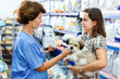 © JackF - Elderly female veterinarian recommending pet food to young woman visiting pet store with her puppy