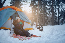 Confident Solo Woman Traveller Camping Through An Evergreen Winter Forest In Canada