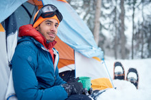 Solo Indian Man Traveller Camping Through An Evergreen Winter Forest In Canada