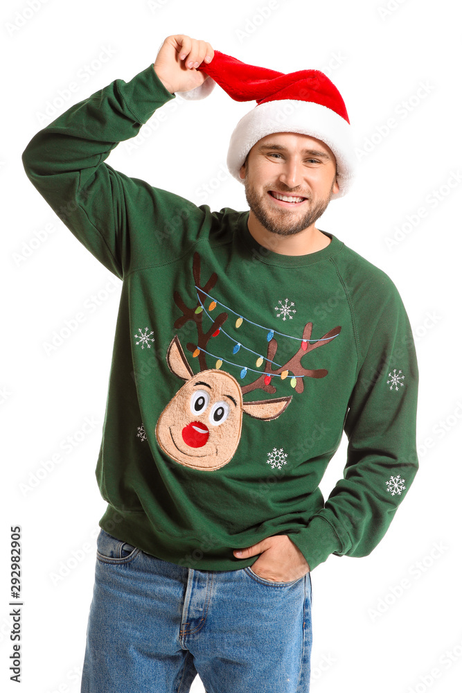 Young man in Christmas sweater and Santa hat on white background