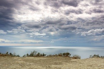 calm landscape sea merging on the horizon with cloudy sky