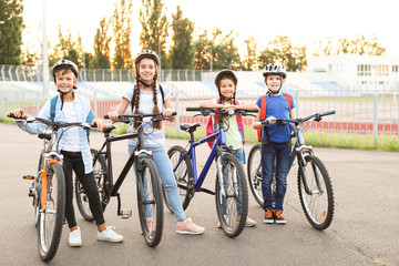 Wall Mural - Cute children riding bicycles outdoors