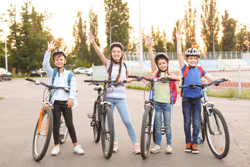 Canvas Print - Cute children riding bicycles outdoors