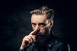 © Fxquadro - Portrait of hopeless bearded man with hairstyle on the black background.