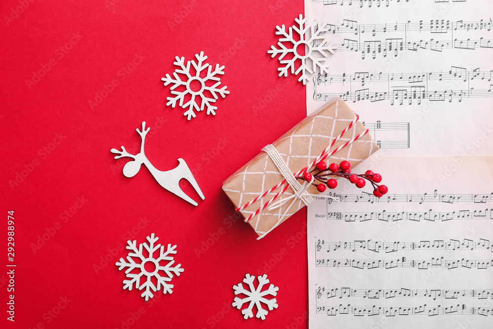 Note sheets, gift and Christmas decor on color background