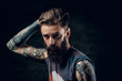 © Fxquadro - Portrait of hopeless bearded man with hairstyle on the black background.