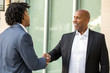 © digitalskillet1 - Mature African American casually dressed businessman shaking hands.