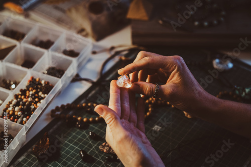 Fotografía Young woman is holding semi precious stone in hands, close up photoshoot