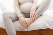 © Prostock-studio - Pregnant woman massaging her swollen foot sitting on bed
