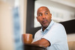 © digitalskillet1 - Mature African American man working from his home office.
