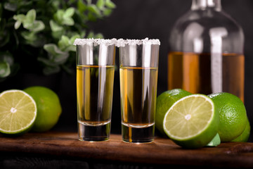 Wall Mural - Mexican Gold Tequila with lime and salt on black background with copyspace.