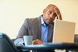 © digitalskillet1 - African American man having a difficult time at work.