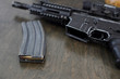 © Peter Kim - High capacity magazine with bullets next to an AR15 on a table in a home.