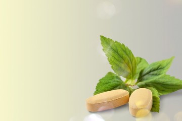 Sticker - Organic pills with mint leaves on  background