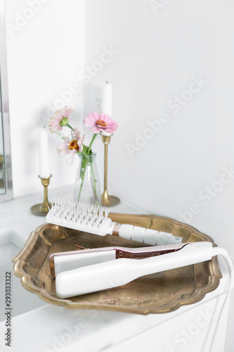 Modern Hair Straightener And Brush On Vintage Gold Brass Tray White Marble Countertop Decor With Candles And Flowers Girly Bathroom Copy Space Buy This Stock Photo And Explore Similar Images At
