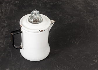 white coffee pot on black rustic background table 