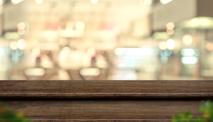 Aufkleber - Empty step dark wood table top food stand with blur people in coffee shop background bokeh light.Mock up for display or montage of product,Banner for advertise on online media,business presentation